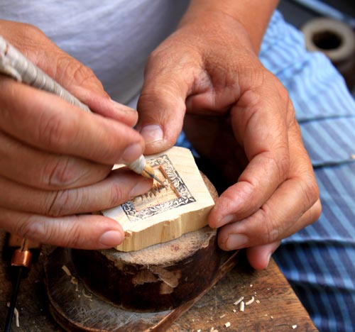 Artisan making a wooden seal - Gift from Hanoi city tour